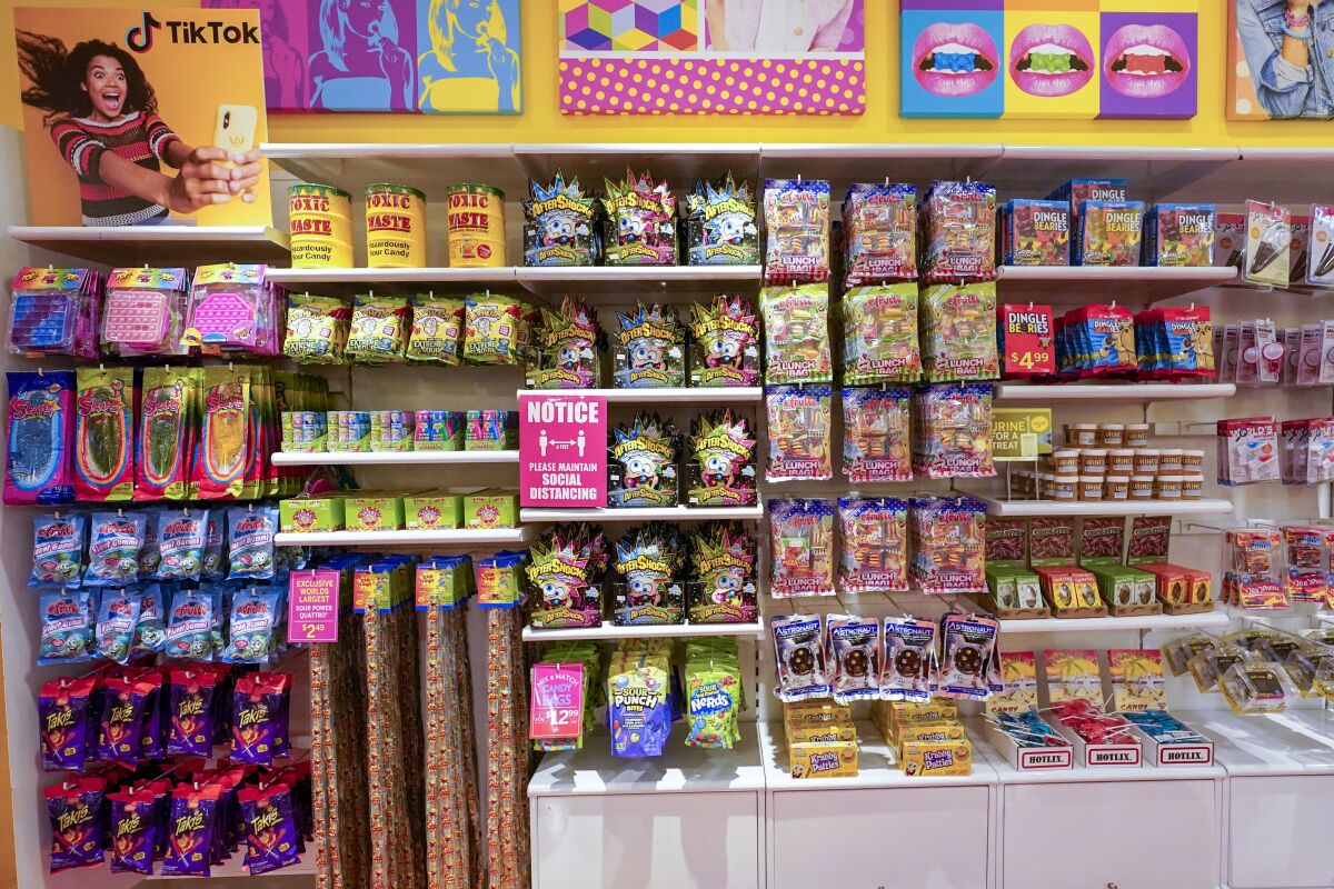 A column of candy, left, featured in TikTok videos is displayed at It'Sugar candy store, Wednesday, Oct. 6, 2021, on the Upper East Side of New York. (AP Photo/Mary Altaffer)