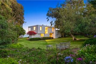 The one-acre estate above Point Dume includes a 1,700-square-foot home, multiple lawns and a flagstone patio overlooking the ocean.