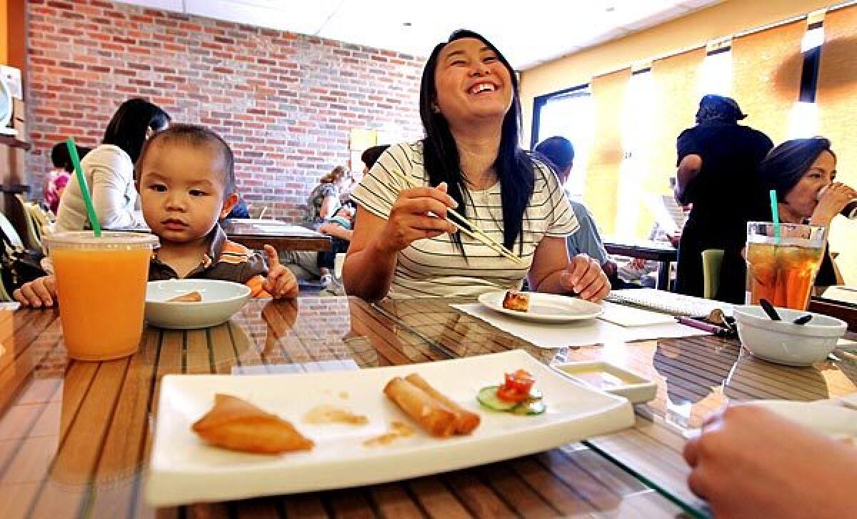 Katie Mac, right, and her son Kyle Fung, who is 21 months old, eat lunch at Green Zone.