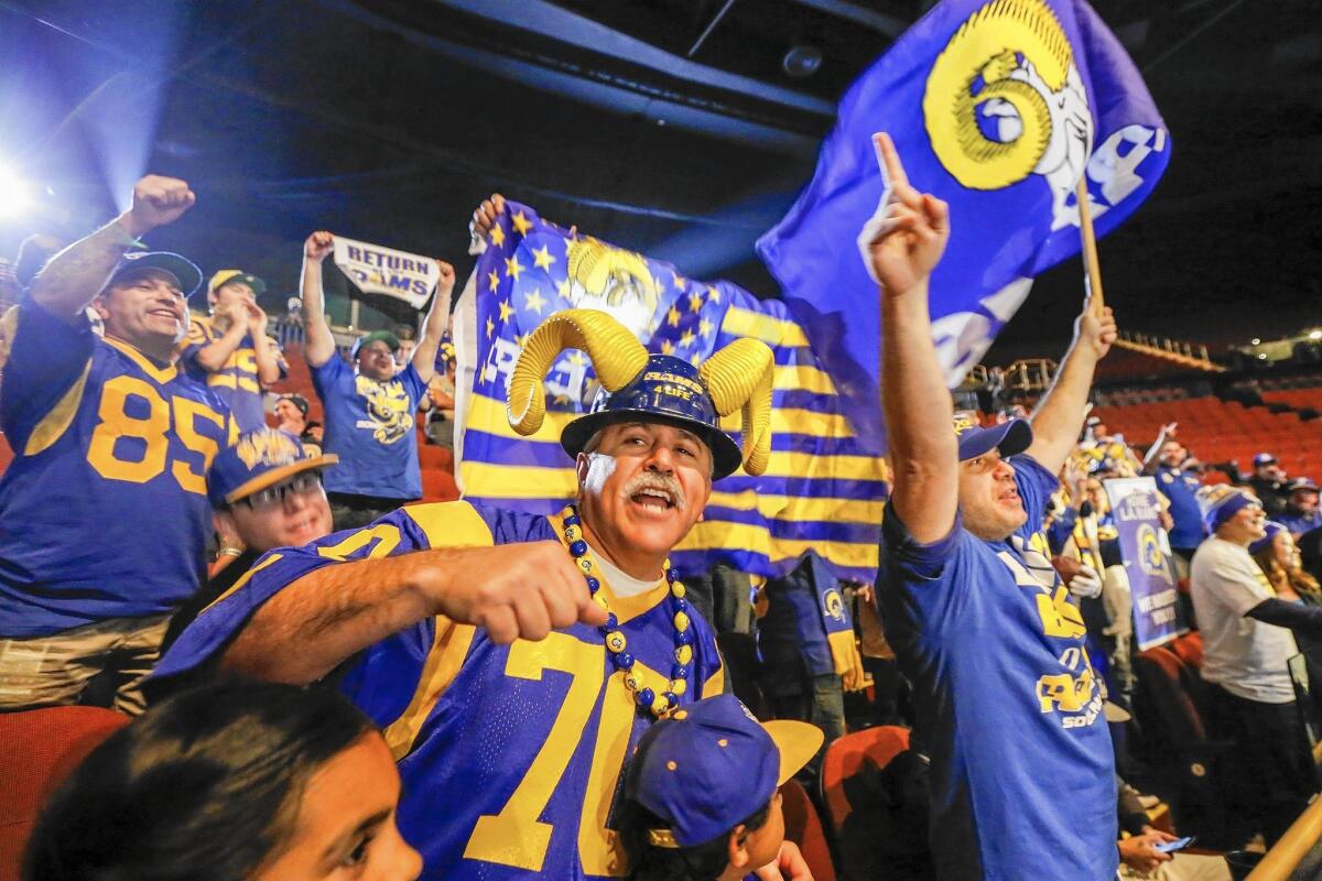 Rams fans attend a news conference in Inglewood with the city's mayor, James Butts Jr., and team owner Stan Kroenke on Jan. 15 to welcome the team back.