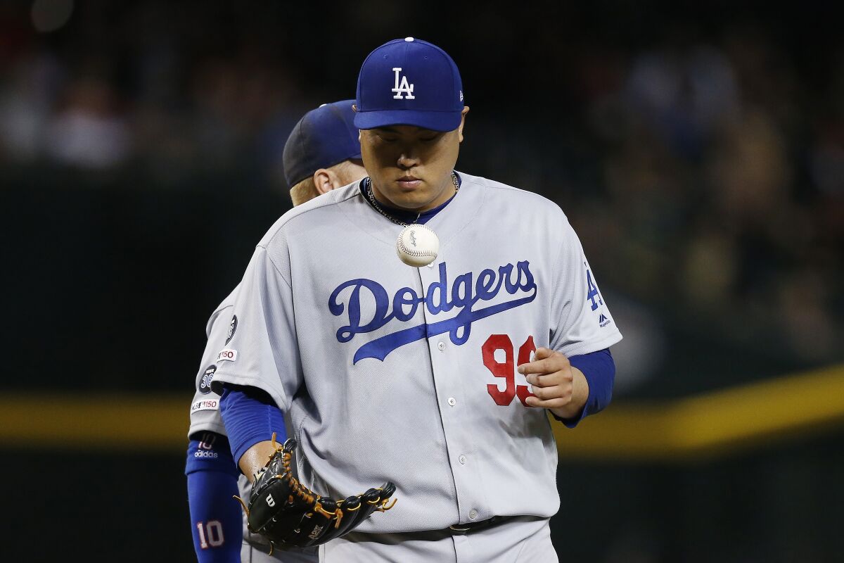 Dodgers starter Hyun-Jin Ryu flips the ball just before being pulled from the game.