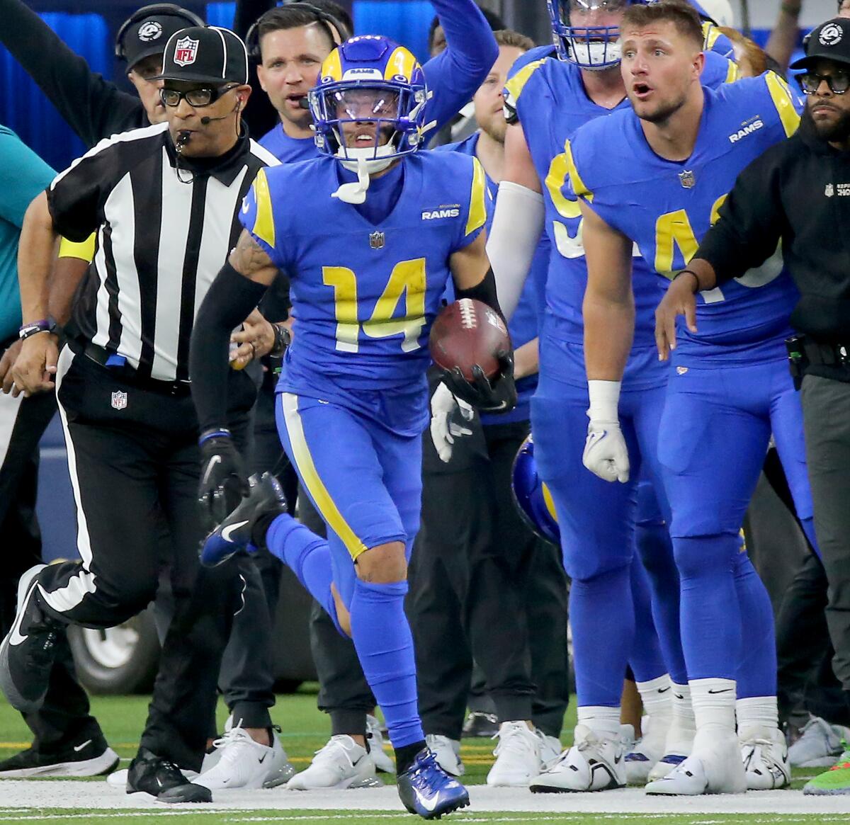 The Rams' Cobie Durant returns an interception for a touchdown against the Broncos in the fourth quarter.