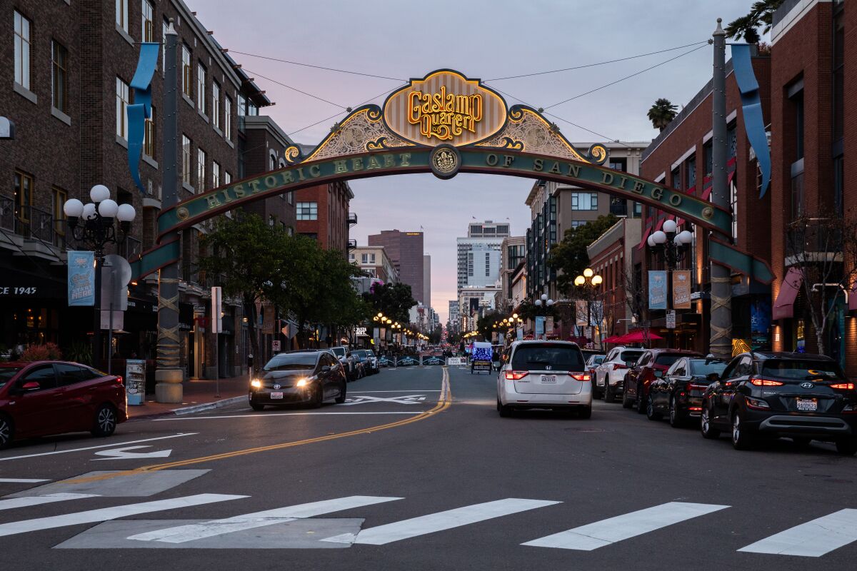 Pedestrians walk through the Gaslamp Quarter at downtown in San Diego.