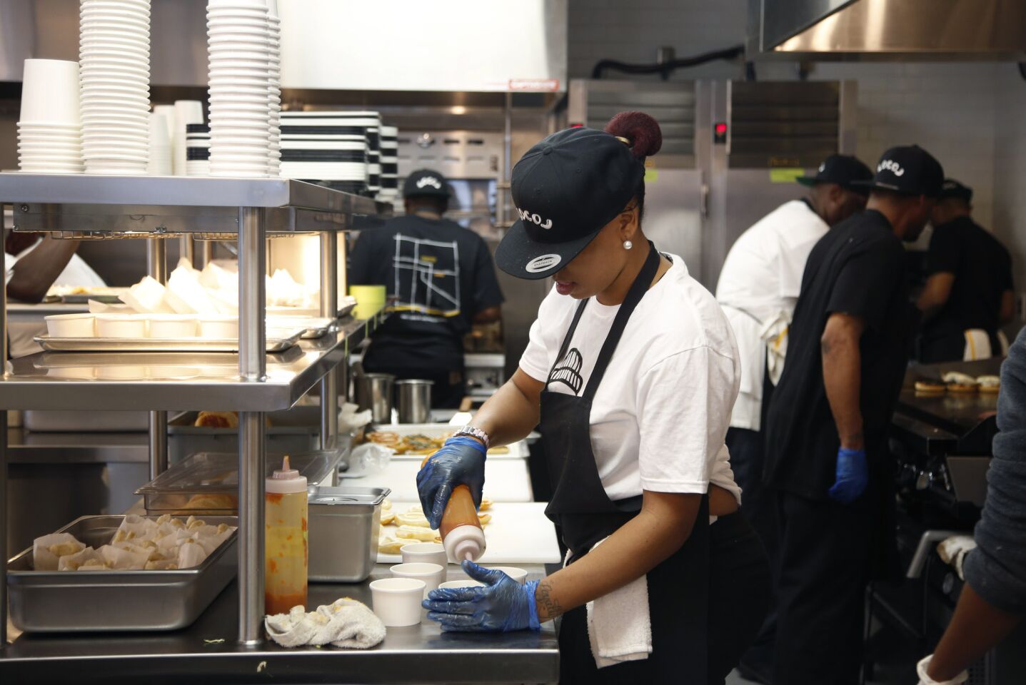 Food is prepared behind the counter at LocoL, whose mission is to transform what the U.S. defines as "fast food."