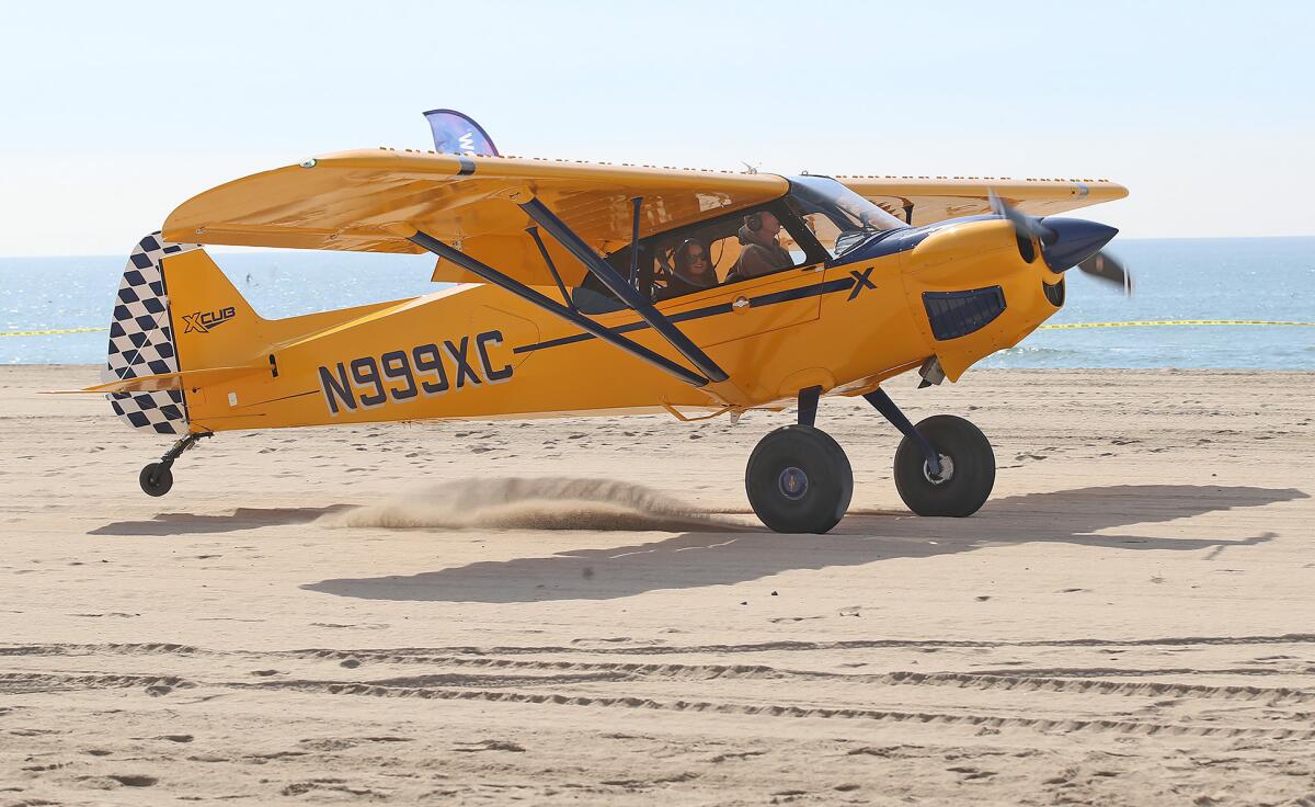 A STOL plane makes a landing with Huntington Beach Mayor Gracey Van Der Mark during Thursday's Pacific Airshow event.
