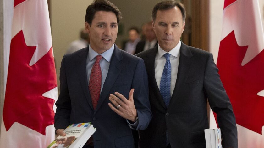 Prime Minister Justin Trudeau and Finance Minister Bill Morneau walk to the House of Commons in Ottawa on March 19.