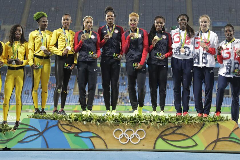 Women's 1,600-meter relay teams from Jamaica, U.S., and Great Britain stand together on the podium during the 2016 Olympics.