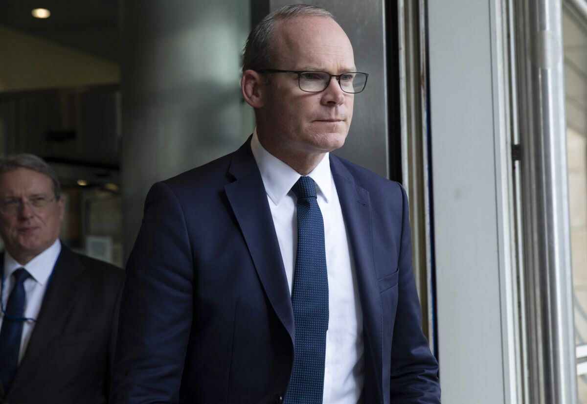 FILE - Irish Foreign Minister Simon Coveney leaves EU headquarters in Brussels, Sept. 27, 2019. The British and Irish governments are expressing optimism that a thorny spat between the U.K. and the European Union over Northern Ireland trade can be resolved. Irish Foreign Minister Simon Coveney said Thursday, Dec. 2, 2021 there hasn’t been a “breakthrough moment” in talks over post-Brexit rules for Northern Ireland, the only part of the U.K. that shares a border with an EU member. (AP Photo/Virginia Mayo, file)