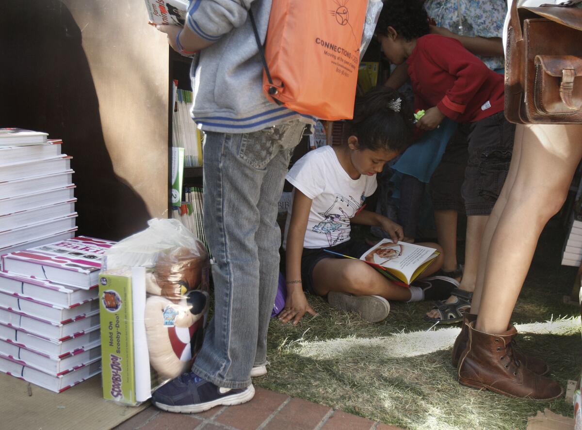 Alexis Nicholson, 9, reads a printed book at the 2013 Los Angeles Times Festival of Books.