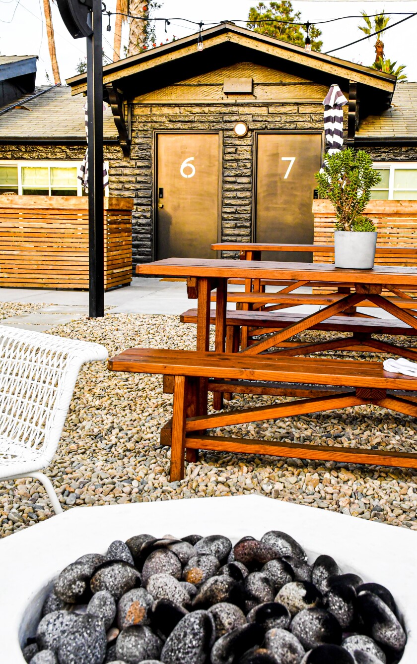 Once-overlooked Oceanside has a new vibe. Visit now before it becomes a tourist hotspot 20 A fire pit and picnic table with hotel doors in the background.