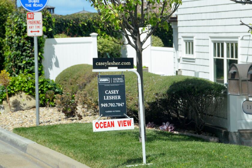 "Ocean View" attached to the home's for sale sign grabs drivers' attention as they make their way along Bayside Drive in Corona del Mar, on April 26, 2021.