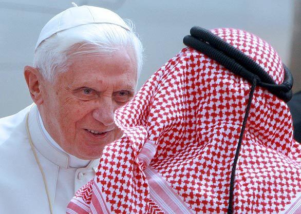 Pope Benedict XVI is greeted by a Jordanian official on his arrival in Amman, as the pontiff begins his eight-day tour.