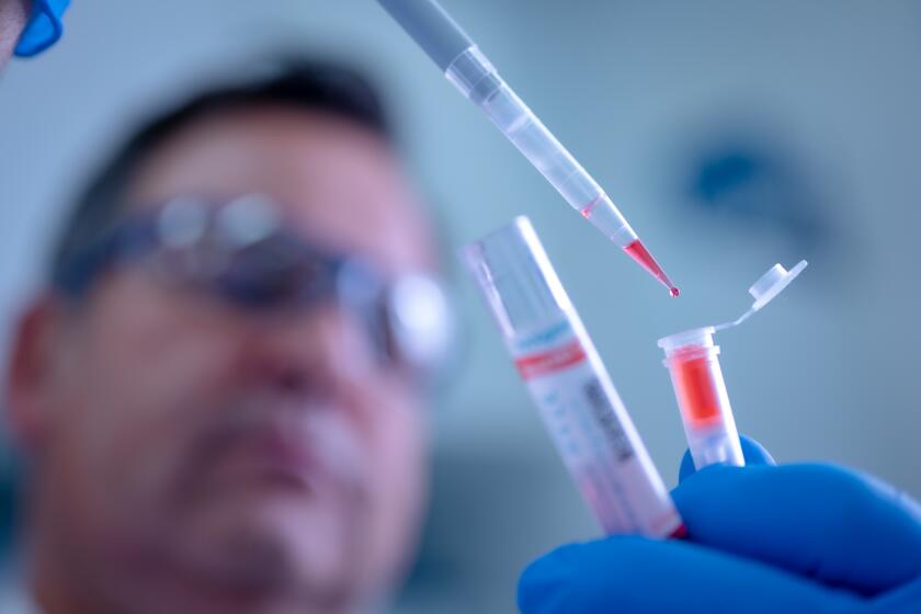 HILDEN, GERMANY - MARCH 11: An employee of German biotech company Qiagen demonstrates the use of the QIAamp Viral RNA Mini Kit testing device for infectious diseases at the Qiagen plant on March 11, 2020 in Hilden, Germany. Qiagen has modified the device for testing fluid samples for coronavirus infection and Qiagen is seeking to deliver it to hospitals, clinics and doctors across Europe. Germany has registered approximately 1,200 cases of coronavirus infection and recently reported its first two deaths. (Photo by Sascha Schuermann/Getty Images)