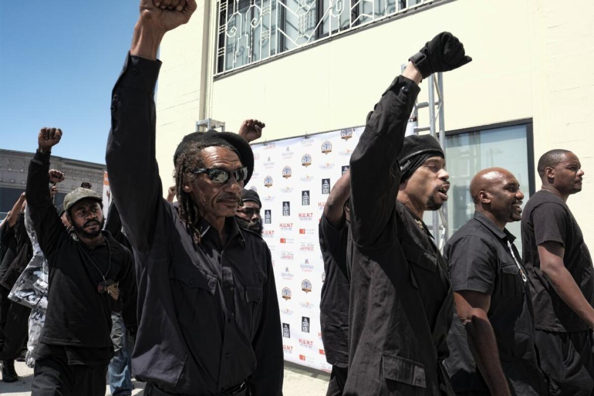 Marchers calling themselves a new generation of the Black Panther Party gather in Los Angeles on July 17 for a community summit titled "Time to Unite: United Hoods + Gangs Nation."