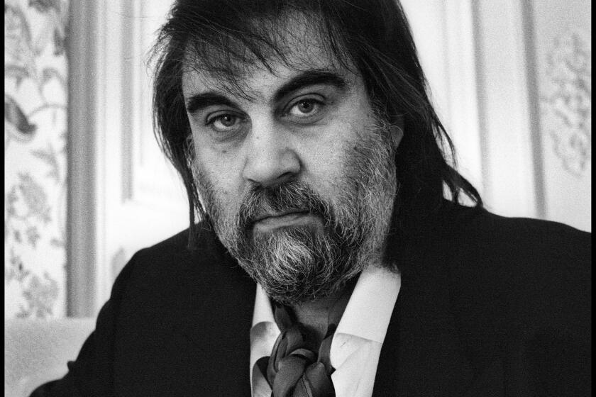 Greek composer and keyboard player Vangelis poses at his apartment in Paris, 9th June 1991. (Photo by Rob Verhorst/Redferns)
