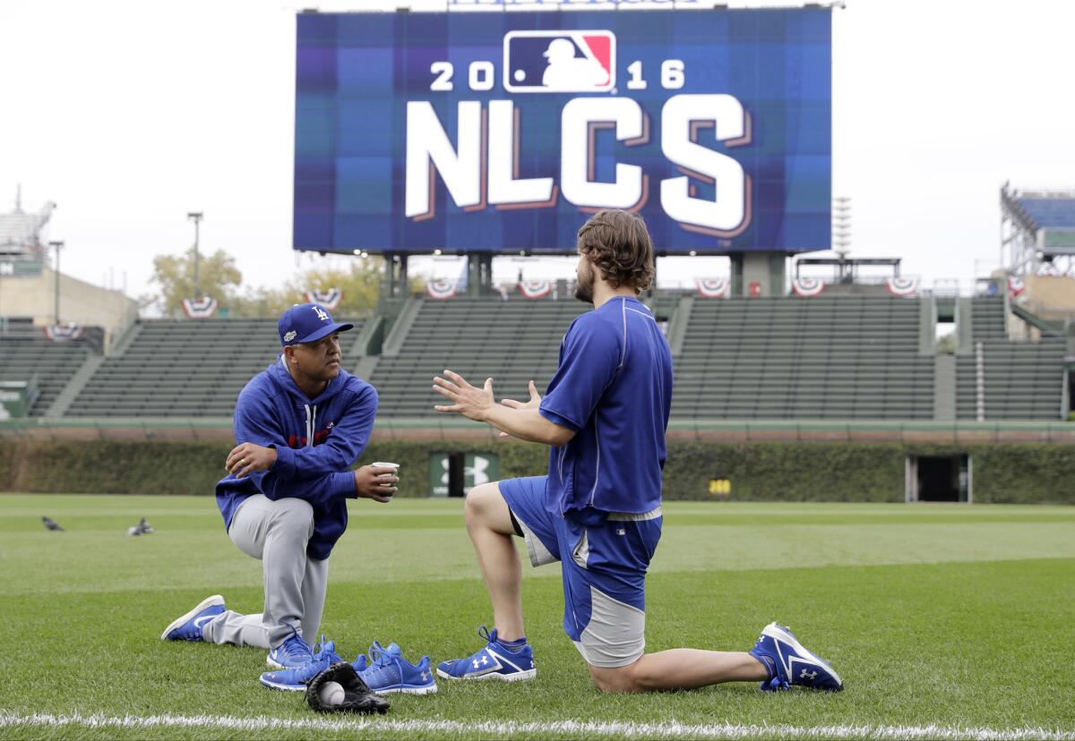 Clayton Kershaw talks to Dave Roberts before Game 1.