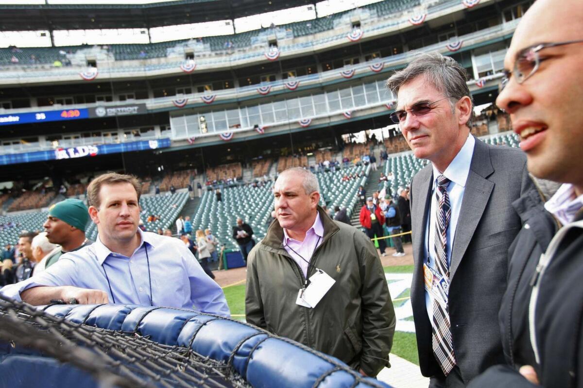 Assistant General Manager David Forst, Director of Professional Scouting/Baseball Development Dan Feinstein, General Manager Billy Beane and Director of Baseball Operations Farhan Zaidi of the Oakland Athletics stand at the batting cages prior to the game against the Detroit Tigers at Comerica Park on October 6, 2012.