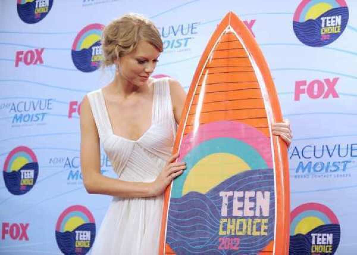 Taylor Swift shows off one of her awards at Sunday's 2012 Teen Choice Awards ceremony in Los Angeles.