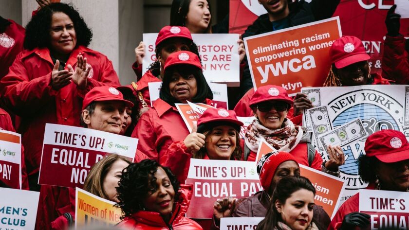 People rally on Equal Pay Day on April 10 on the steps of New York City Hall.