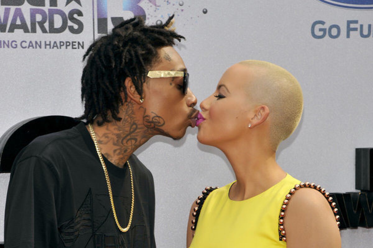 Wiz Khalifa, left, and Amber Rose — smooching at the BET Awards in June — got married Monday.