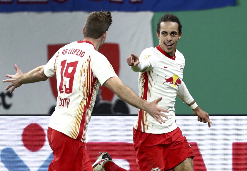 Leipzig's scorer Yussuf Poulsen, right, and his teammate Alexander Sorloth, left, celebrate the opening goal during the German soccer cup, DFB Pokal, quarter final match between RB Leipzig and VfL Wolfsburg in Leipzig, Germany, Wednesday, March 3, 2021. (AP Photo/Michael Sohn)