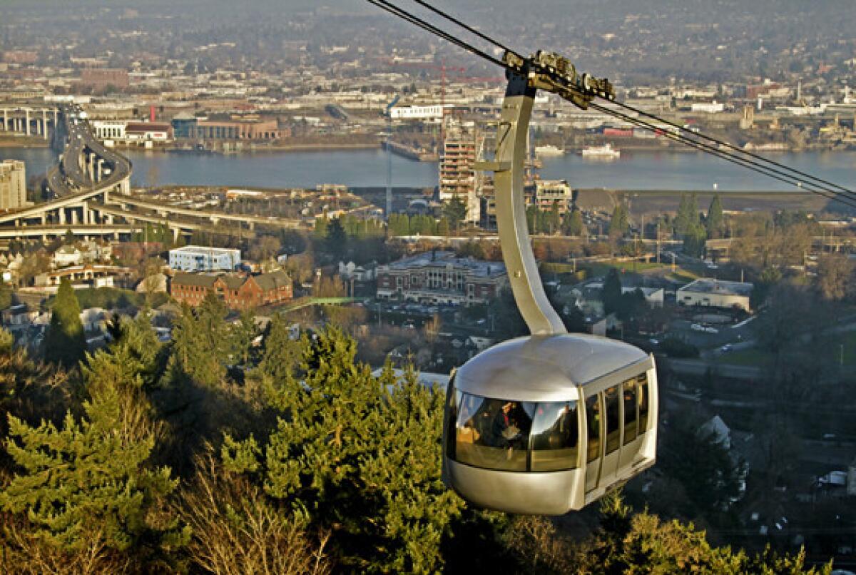 The Portland Aerial Tram, with the Willamette River and Ross Island Bridge in the background.