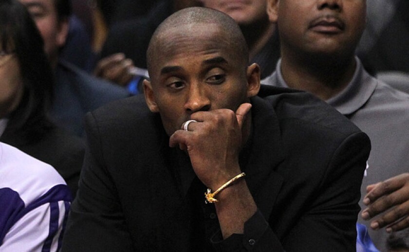 Injured Lakers star Kobe Bryant looks on during a blowout loss to the Clippers on Jan. 10. Is there any good reason for Bryant to play again this season?