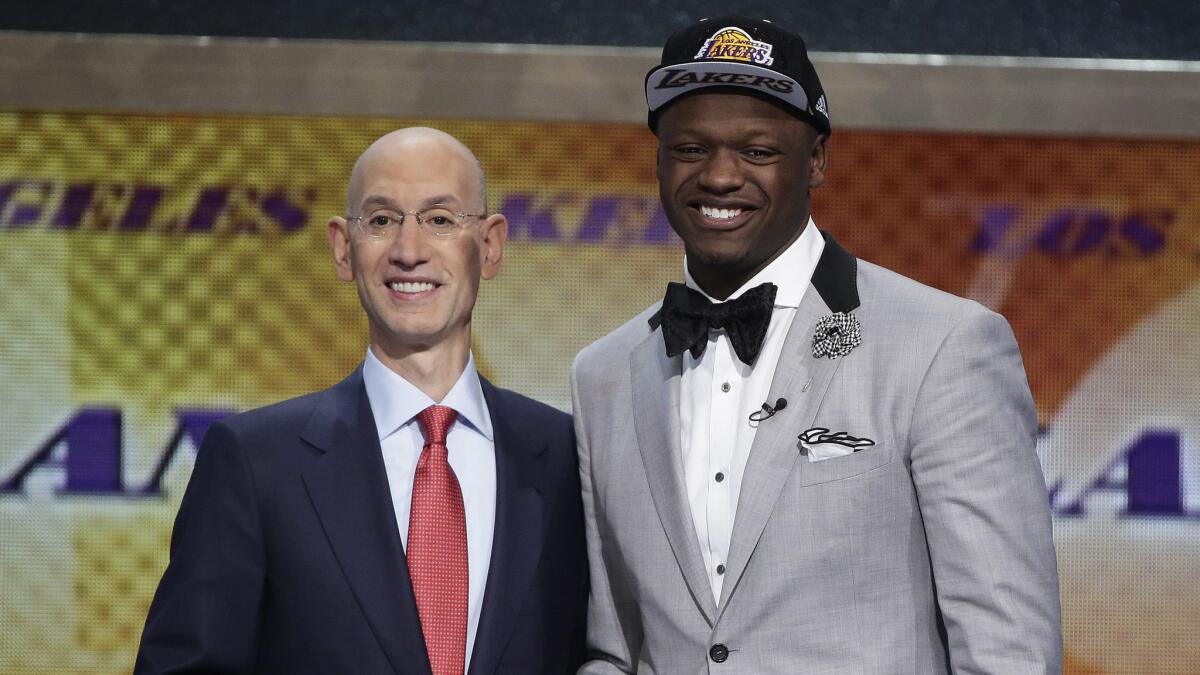 NBA Commissioner Adam Silver with Lakers' 2014 first round draft pick Julius Randle. The Lakers will find out their 2015 draft lottery fate on Tuesday.