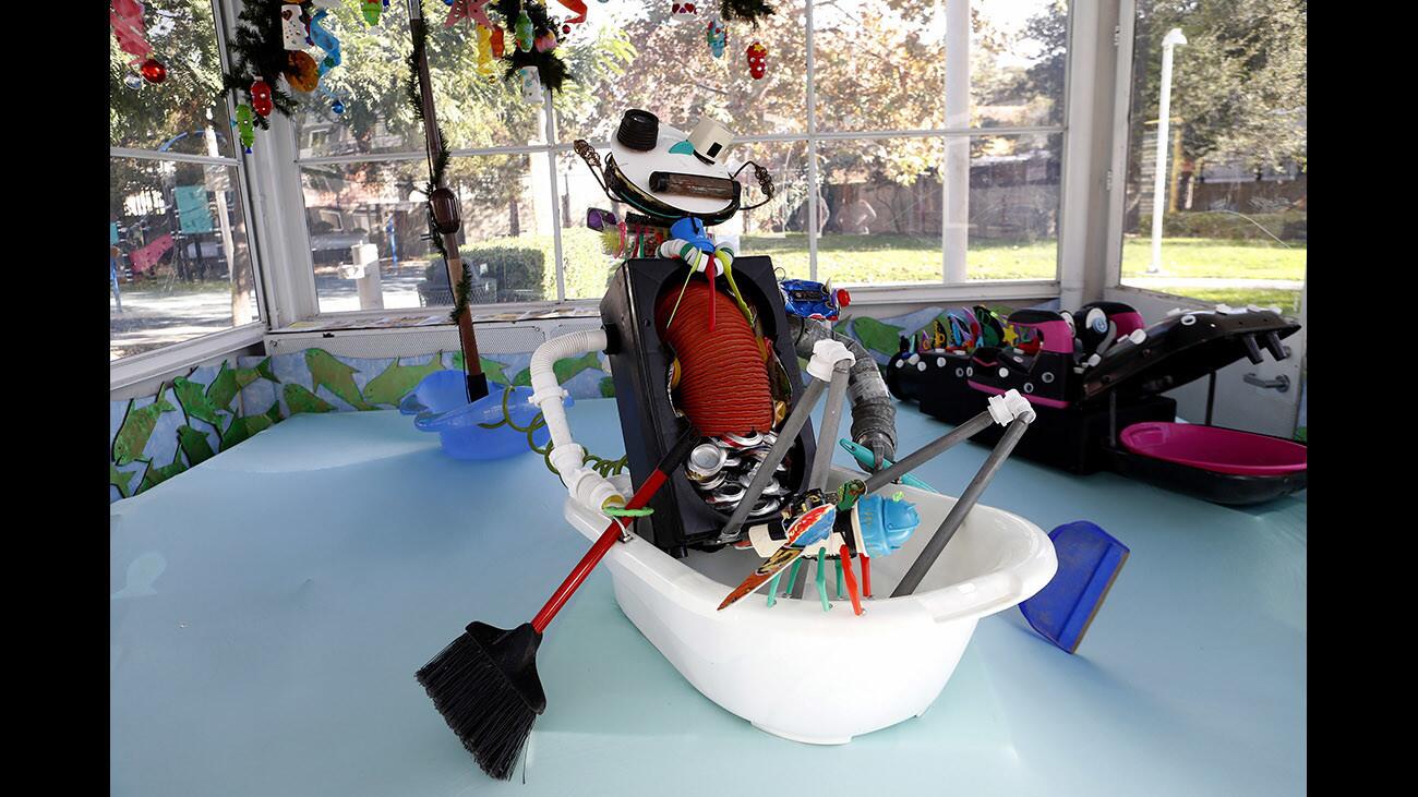 Adams Hill resident and artist Cathy Hrenda's art piece ‚"We're All In The Same Boat" is on display now at the Richfield Gas Station, Adams Square Mini Park, in Glendale on Tuesday, Nov. 28, 2017. Hrenda created her artwork from trash she fond throughout Glendale. Trash used includes a large picnic table umbrella, plastic tub, aluminum cans, bottles and other items.