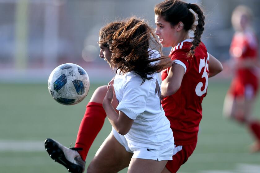Burbank girls soccer player Jessie Virtue, right, battles for the ball in game vs. Arcadia, at home in Burbank on Tuesday, Jan. 7, 2020.