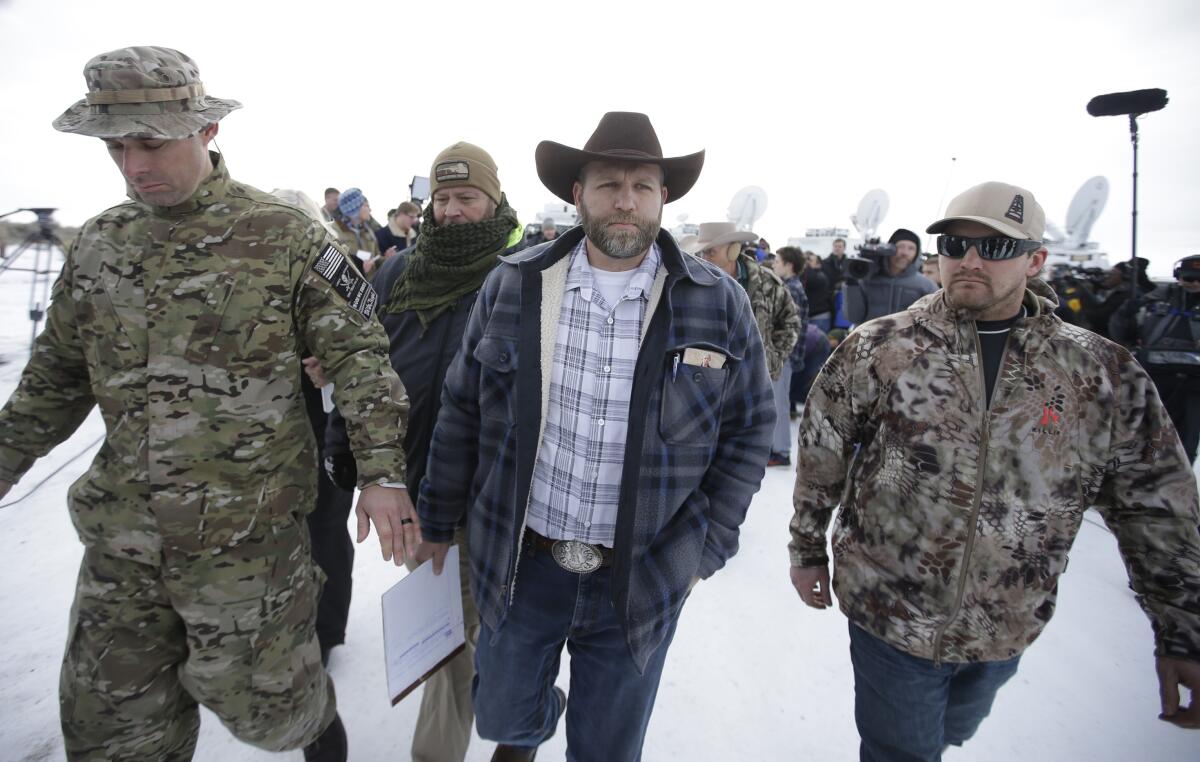 Ammon Bundy walks off after speaking with reporters