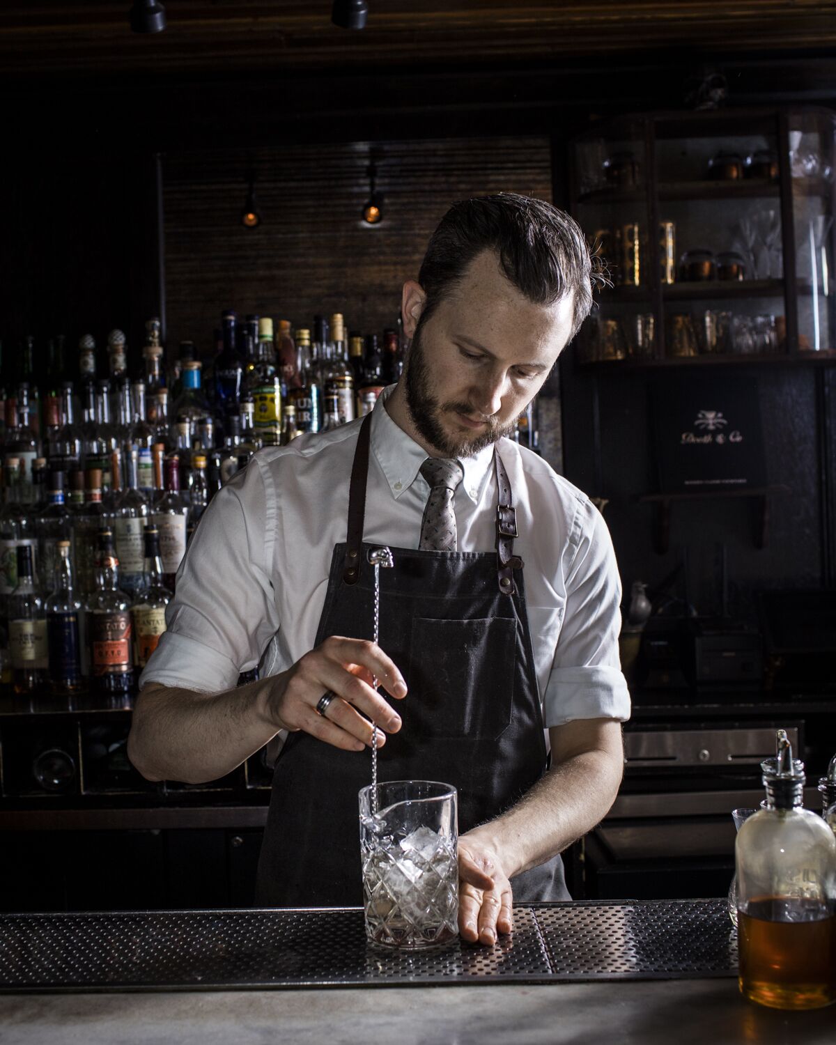 Bartender Matthew Belanger fixes a drink at Death & Co. The bar will open a location in L.A. in November.