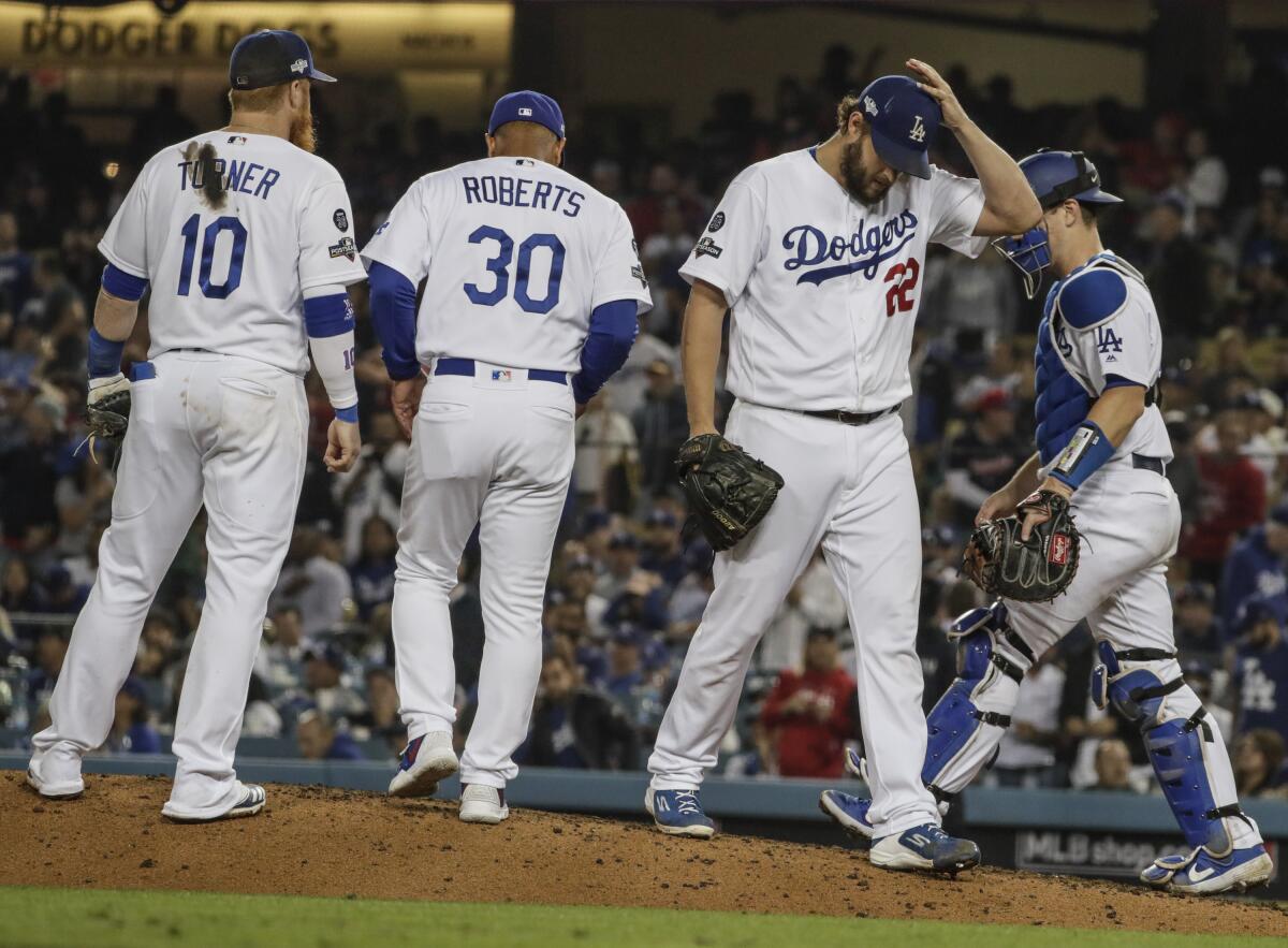 Dodgers relief pitcher Clayton Kershaw (22) leaves the game after giving up a homer to Washington Nationals left fielder Juan Soto (22) in Game 5 of the NLDS at Dodger Stadium on Wednesday.