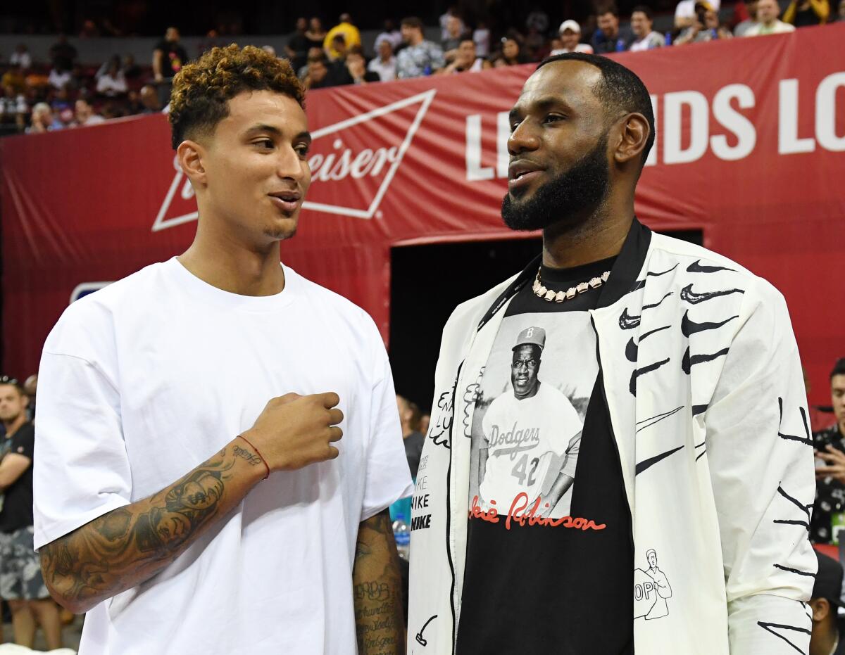 Kyle Kuzma chats with Lakers teammate LeBron James during the Las Vegas Summer League.