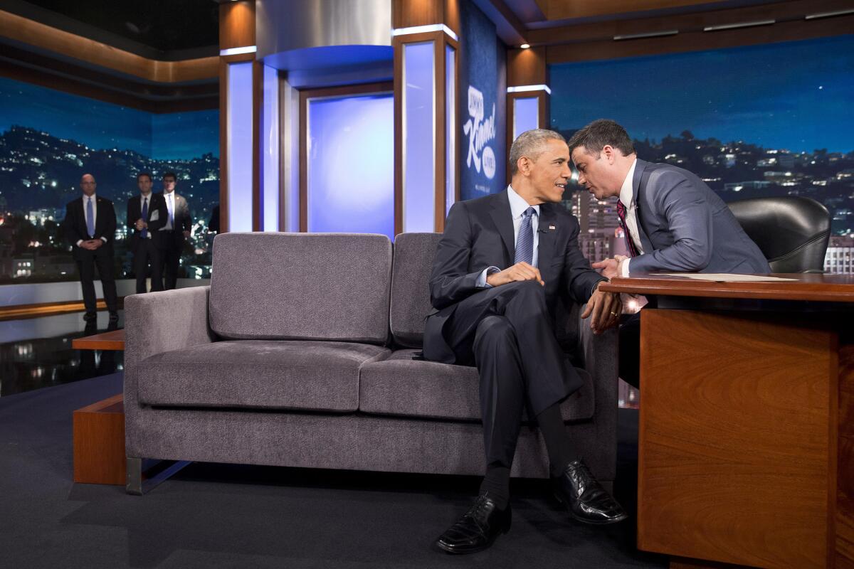 Secret Service agents look on as President Obama talks with Jimmy Kimmel during a break in taping "Jimmy Kimmel Live."