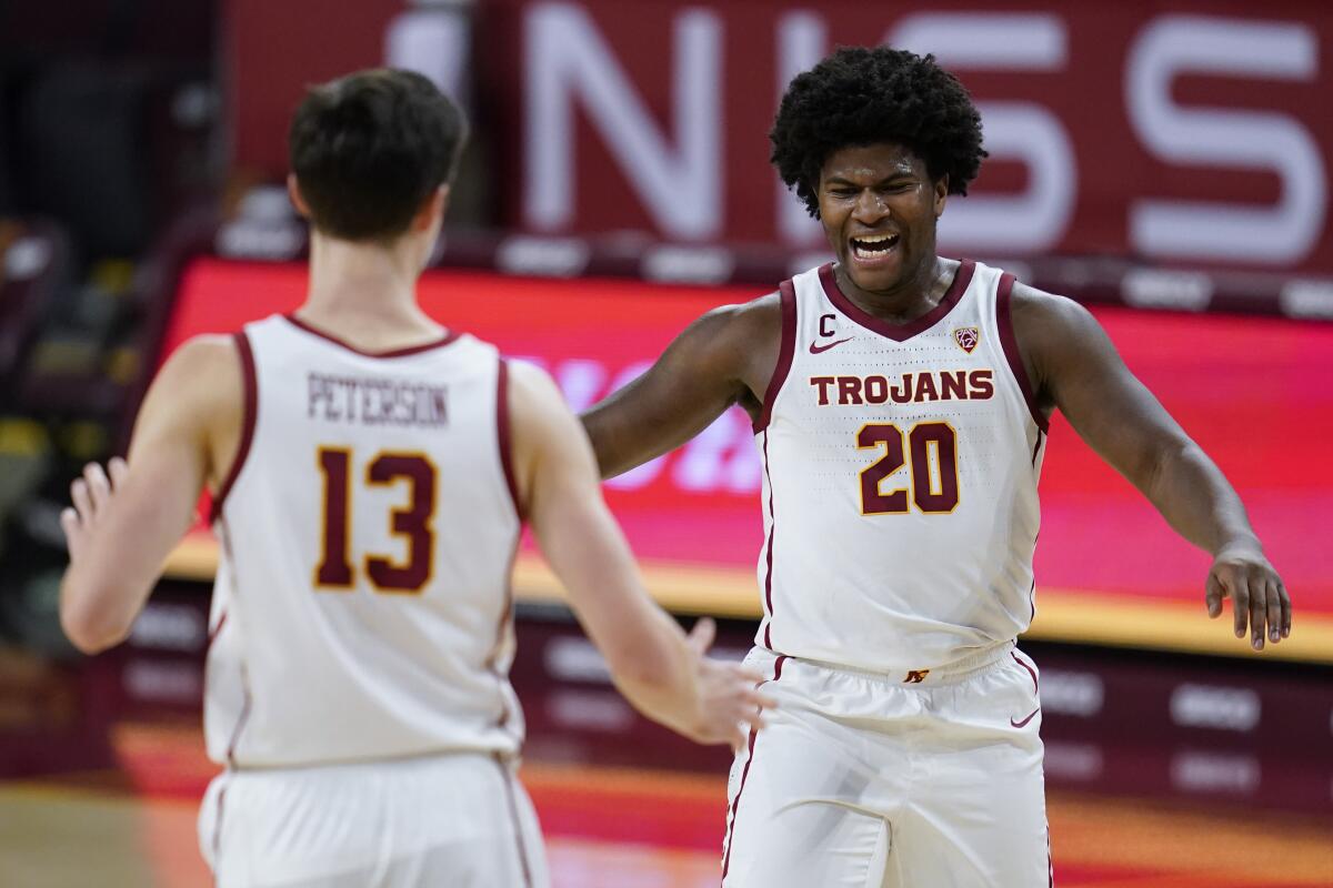 USC guard Drew Peterson and guard Ethan Anderson celebrate during a timeout.