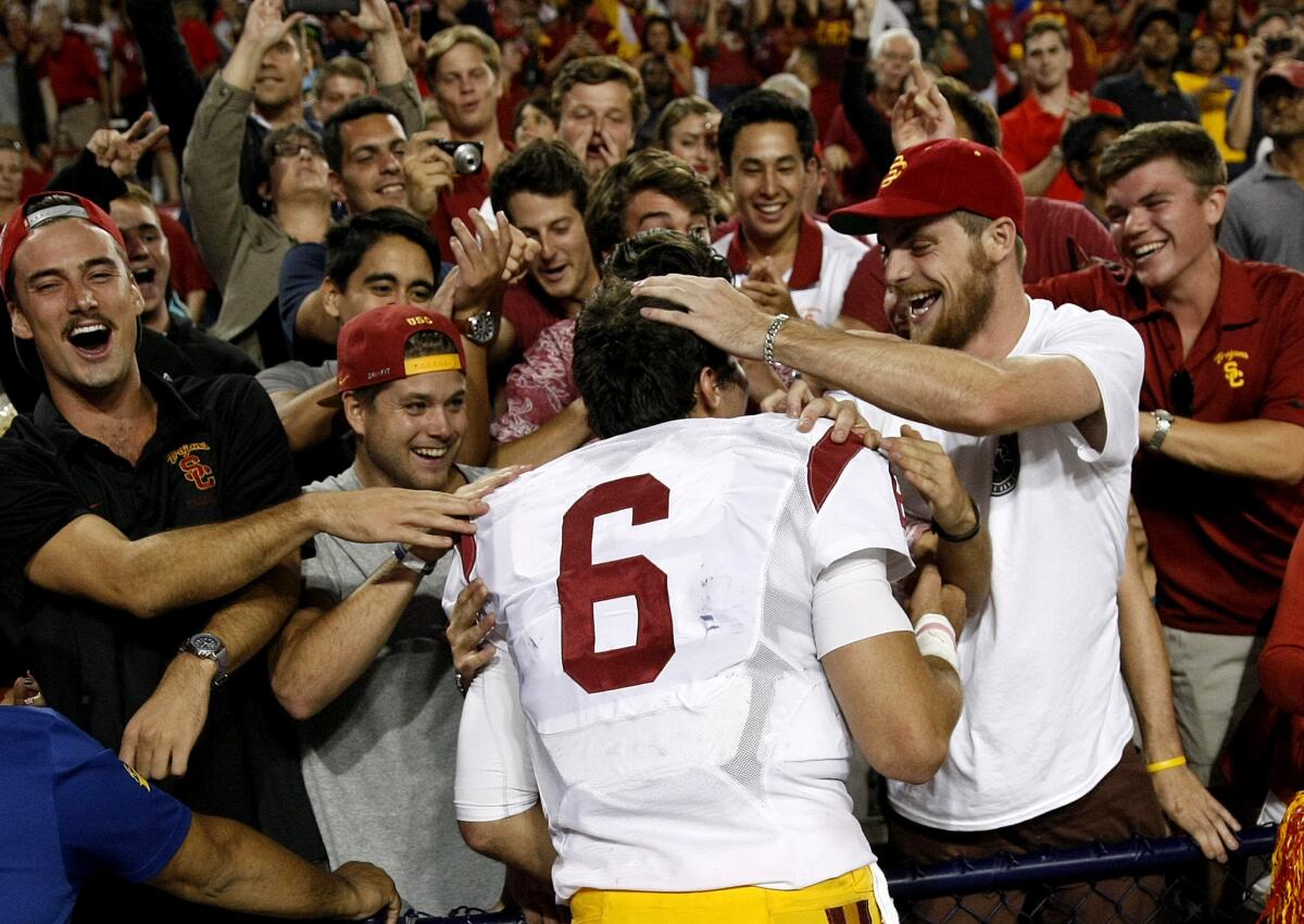 USC quarterback Cody Kessler (6) celebrates with fans after the Trojans defeat Arizona, 28-26, on Saturday.