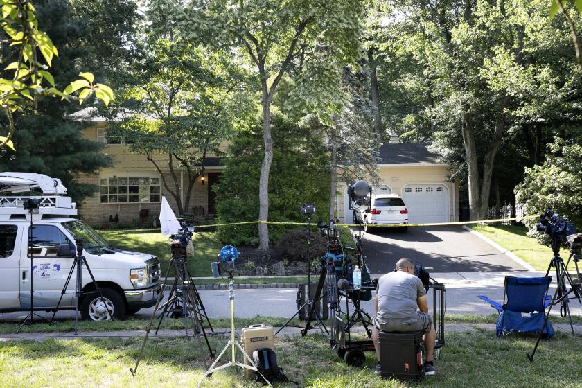 News media is set up in front of the home of U.S. District Judge Esther Salas, Monday, July 20, 2020, in North Brunswick, N.J. A gunman posing as a delivery person shot and killed Salas' 20-year-old son and wounded her husband Sunday evening at their New Jersey home before fleeing, according to judiciary officials. (AP Photo/Mark Lennihan)