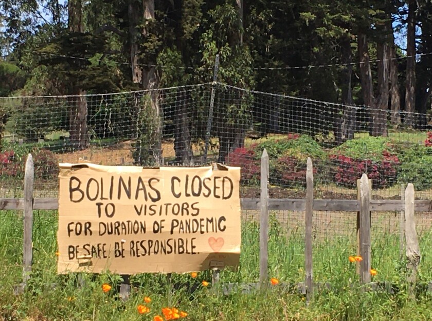 A sign hangs outside of Bolinas, Calif., warning visitors to stay away.