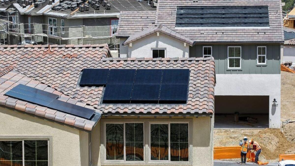 Solar panels are installed on the roofs of some of the newly built homes at the Weston housing development in Santee, Calif.