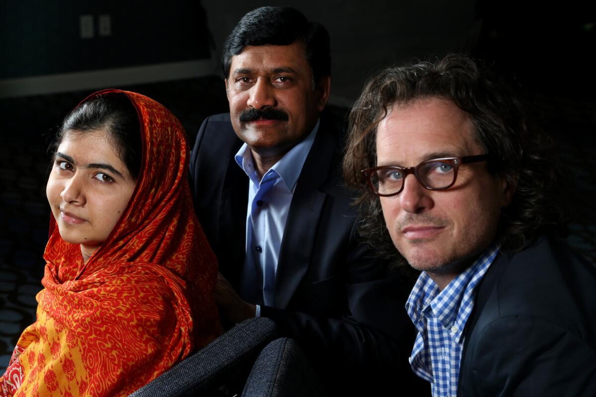 Pakistani teenager Malala Yousafzai, left, has emerged as a leading advocate for children's rights and the youngest-ever Nobel Peace Prize laureate. She is with her father Ziauddin Yousafzai, and director Davis Guggenheim, right.