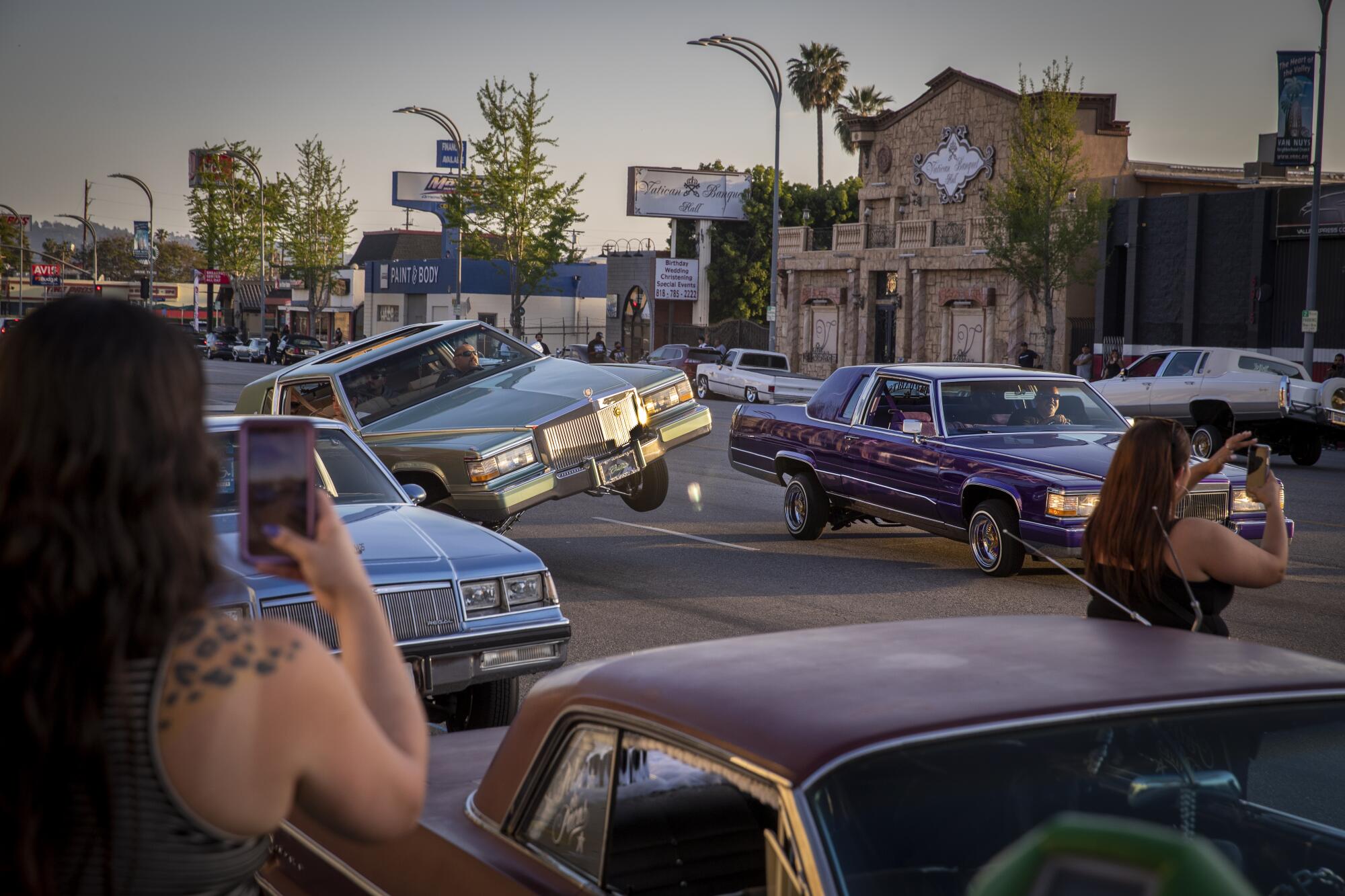 Cars cruise along Van Nuys Boulevard during a sanctioned event in April 2021.