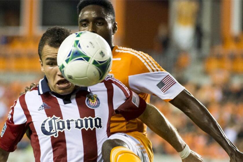 Carlos Alvarez pushes in front of Houston's Warren Creavalle during Chivas USA's 5-1 loss to the Dynamo on Sept. 21.