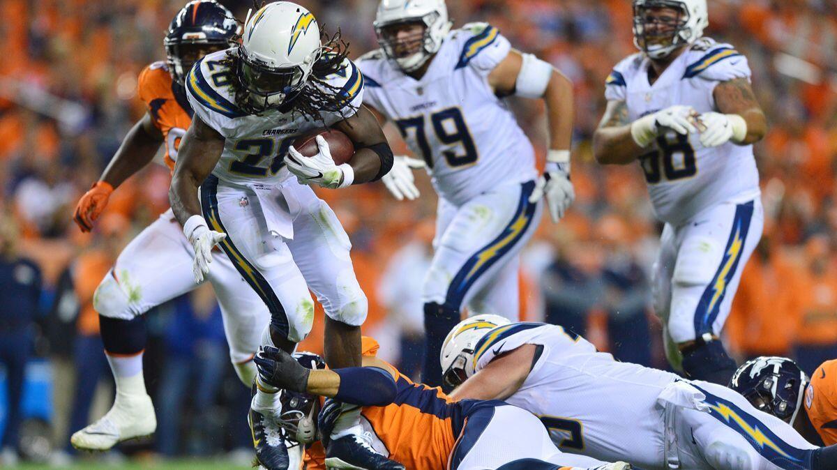 Chargers running back Melvin Gordon (28) rushes for three yards in the second half against the Denver Broncos on Monday.