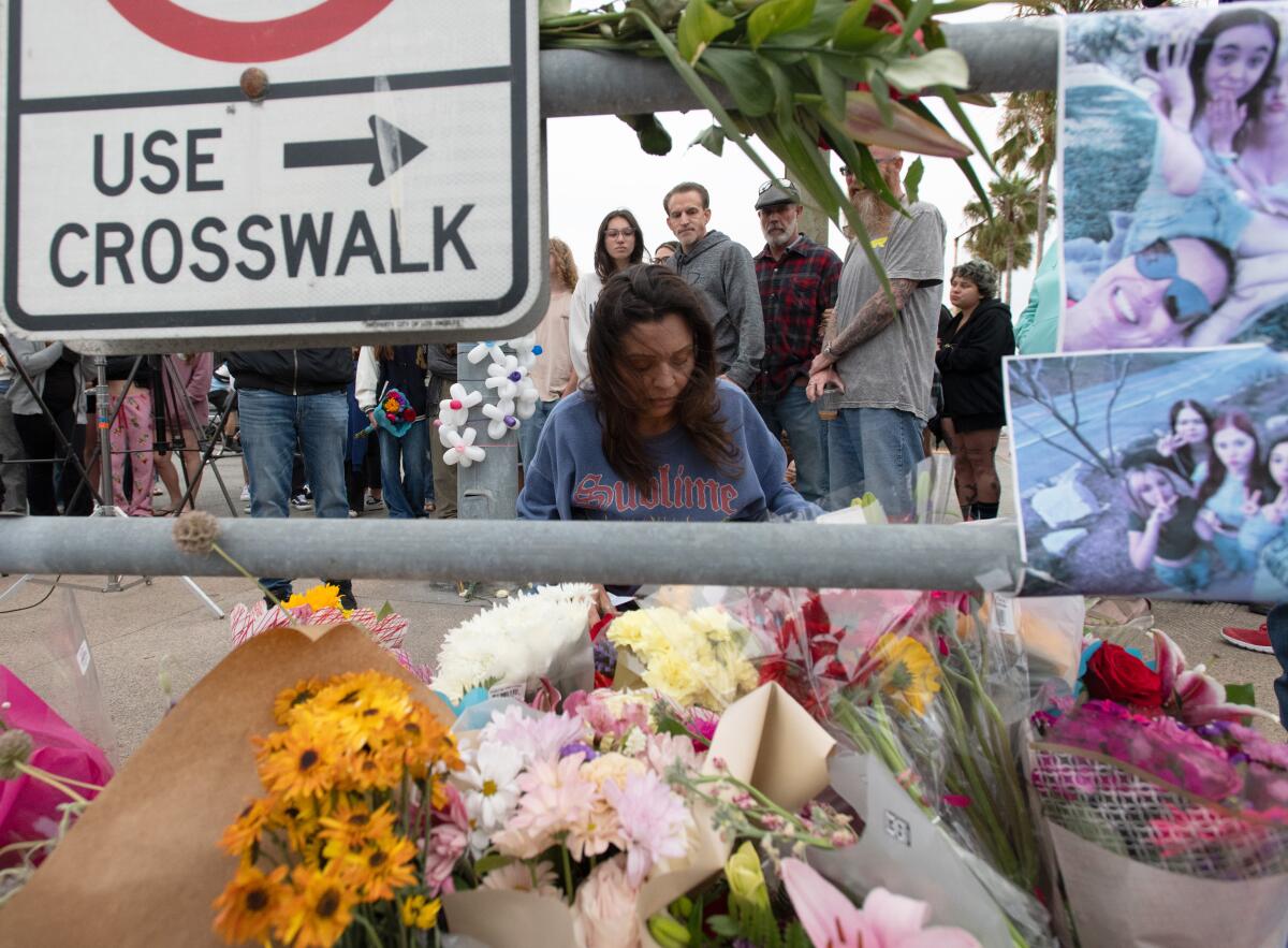 Glori Smiley sits in front of a memorial at Balboa Boulevard and Palm Street in her daughter's memory.