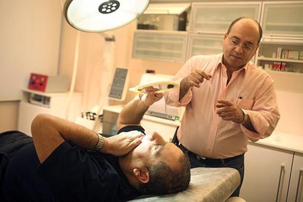 Lebanon is known as the Arab worlds plastic surgery capital. Here, Dr. Fadi Jiz meets with his patient Talal Mansour, who with his wife, Teresa, was chosen to participate on the television program "Beauty Clinic," in which participants are given free plastic surgery.