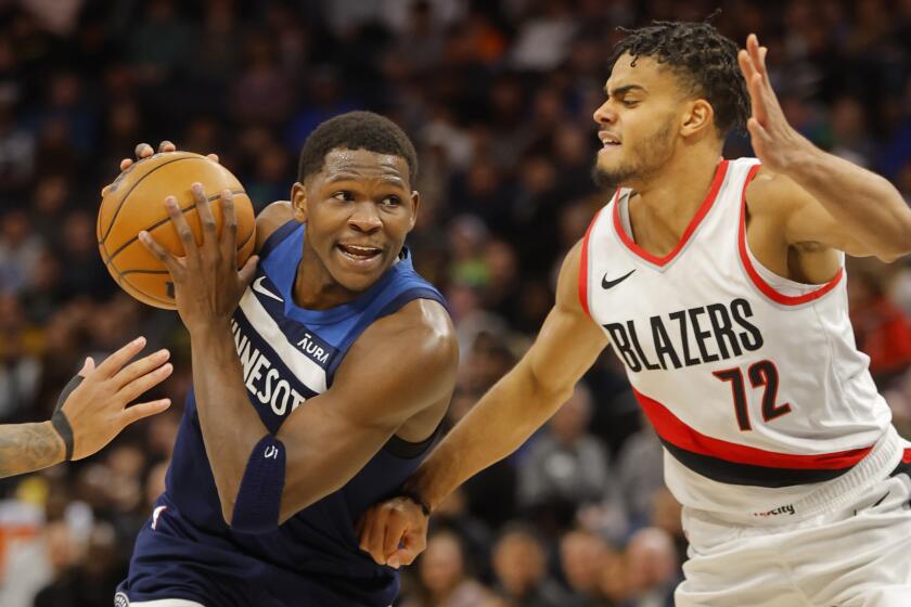 Minnesota Timberwolves guard Anthony Edwards, left, drives past Portland Trail Blazers guard Rayan Rupert (72) in the first quarter of an NBA basketball game Monday, March 4, 2024, in Minneapolis. (AP Photo/Bruce Kluckhohn)
