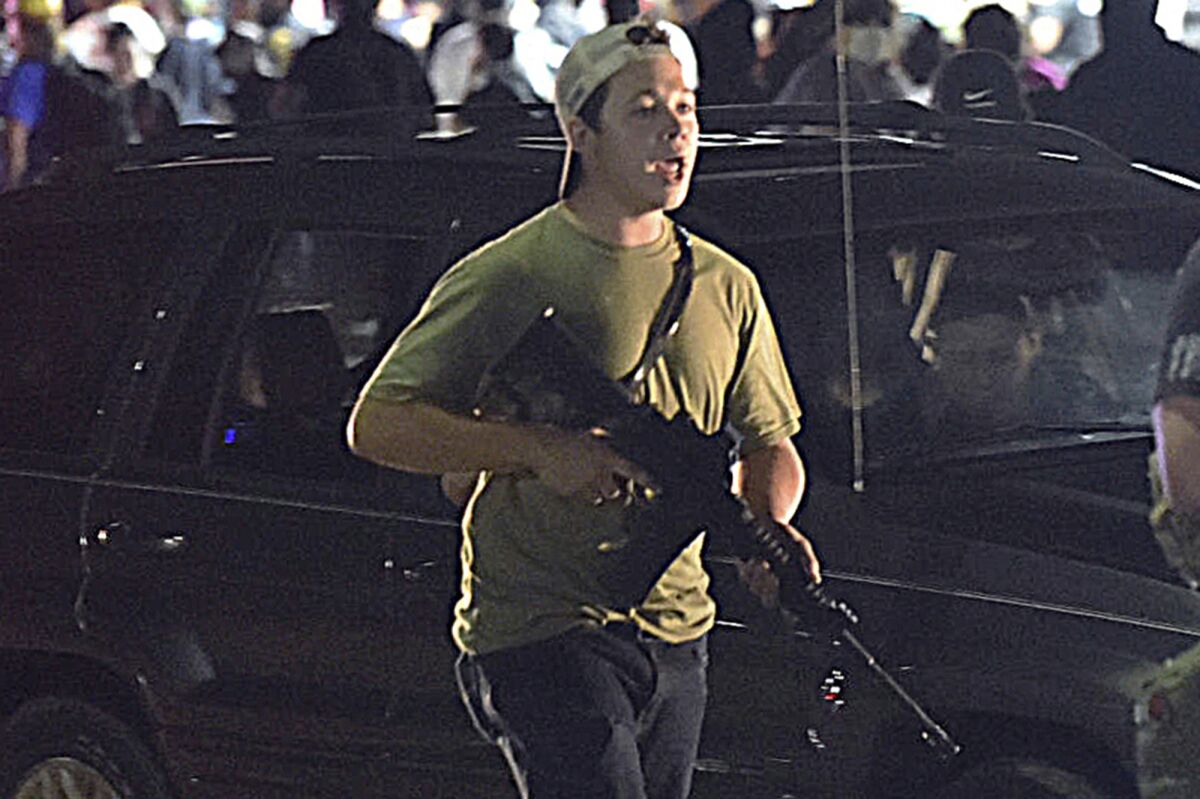FILE - Kyle Rittenhouse walks along Sheridan Road in Kenosha, Wis., in this Aug. 25, 2020 file photo. Before midnight, he used his Smith & Wesson AR-style semi-automatic to shoot three people, killing two. After a roughly two-week trial, a jury will soon deliberate whether Rittenhouse is guilty of charges, including murder, that could send him to prison for life. (Adam Rogan/The Journal Times via AP, File)