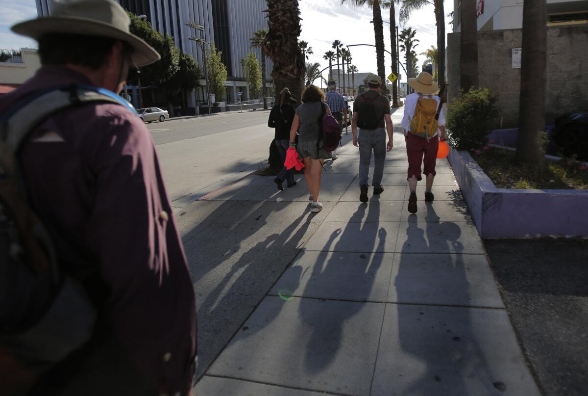 Sierra Club members chat during their annual 16-mile walk along Wilshire Boulevard.