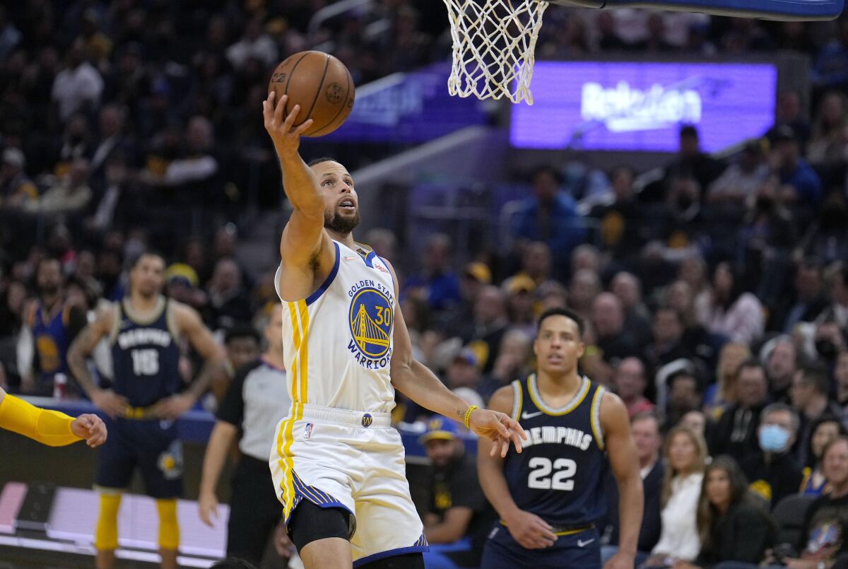 Golden State Warriors guard Stephen Curry (30) drives to the basket past Memphis Grizzlies guard Desmond Bane (22) during the first half of Game 4 of an NBA basketball Western Conference playoff semifinal in San Francisco, Monday, May 9, 2022. (AP Photo/Tony Avelar)